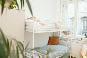 a white bunk bed in a room with a window at Jupiter Home Buda in Budapest