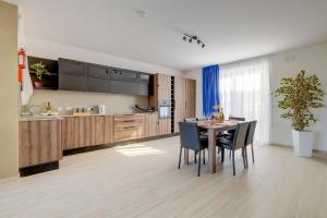 a kitchen and dining room with a table and chairs at Salmar Court Holiday Apartments with Pool in Hal Ghaxiak