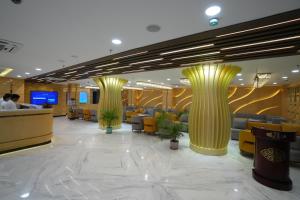 a lobby of a hotel with yellow columns at The Royal Bihar in Patna