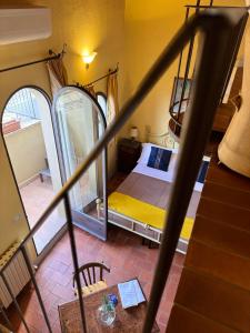 a bedroom with a bed in a room with a staircase at Pienzalettings in Pienza