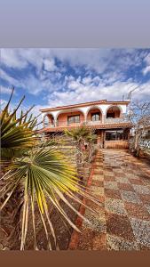 a large house with palm trees in front of it at Athina Villa in Zilotí