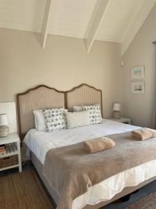 a bedroom with a bed with two pillows on it at Bougain Villa Studio 2 in Paternoster