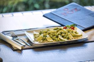 a plate of pasta and vegetables on a table at Elite Hotel & Spa in Mestre +37 photos