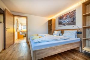 a bedroom with a large blue bed in a room at Rickys Apartment Flachau in Flachau