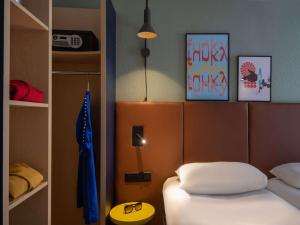 a small bedroom with a bed and a room with at ibis Cannes Centre in Cannes