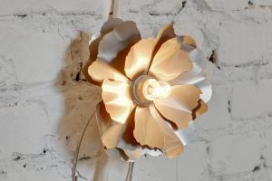 a brown and white flower on a wall at Downtown Apartments Old Town Ogarna Baltus in Gdańsk