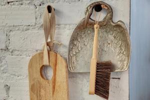 two wooden utensils are hanging on a wall at Downtown Apartments Old Town Ogarna Baltus in Gdańsk