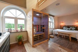 a bedroom with a bed and a glass shower at Instinct - Jacuzzi, Sauna, Apéritif dînatoire et Petit déjeuner 