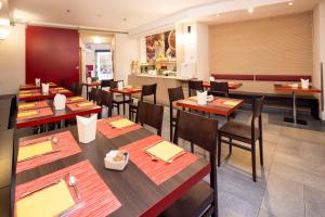 a dining room with wooden tables and chairs at Best Western Porto Antico in Genoa
