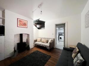 a living room with a couch and a fireplace at Central Cheltenham House - By Suitely in Cheltenham