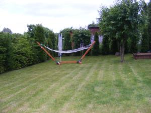 a hammock in the middle of a yard at Dom letniskowy ANTOLEK in Ryn