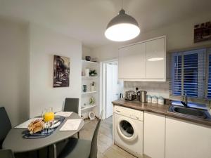 a kitchen with a table with a plate of food on it at Central Cheltenham House - By Suitely in Cheltenham