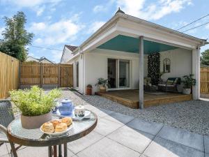 a patio with a table and a house at 1 bed property in Crackington Haven 53410 in Saint Gennys