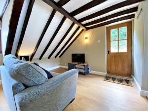 a living room with a couch and a tv at 1 Bed in Exmoor National Park 89766 in Parracombe