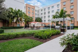 a tennis court in front of a building at Homewood Suites by Hilton West Palm Beach in West Palm Beach