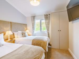 a bedroom with two beds and a window at 2 Bed in Auchenmalg 79129 in Gillespie