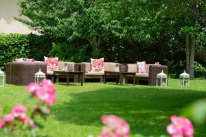 a brown couch with pink pillows sitting in a yard at Hilton Istanbul Bosphorus in Istanbul