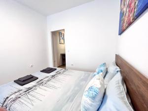 a white bedroom with two beds in it at Peraia Studio in Perea