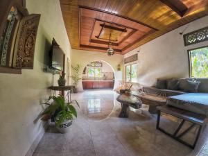 D'Sari Undisan Houses - Abeona Private Villa في Undisan: غرفة معيشة مع أريكة وطاولة