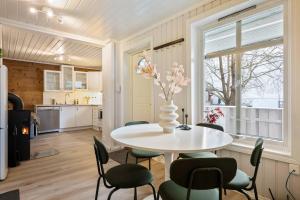 a kitchen and dining room with a table and chairs at Central first floor apartment in Bergen