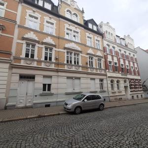 un coche plateado estacionado frente a un edificio en FeWo Dis, en Zeitz