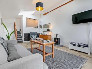 a living room with a couch and a table at 1 Bed in Sennen 93410 in Sennen
