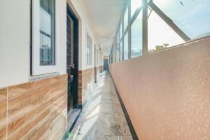 a hallway of a house with wooden floors and windows at OYO Hotel Elite Lifestyle Red Rose Near 7d Voyage in Bangalore