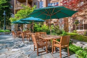 a group of tables and chairs with umbrellas at Hilton Grand Vacations Club Whistler in Whistler