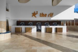 a lobby of a building with a sign on the air at The Rif At Mangrove Beach Corendon All-Inclusive, Curio in Willemstad