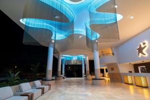 a lobby with blue lights in a building at The Rif At Mangrove Beach Corendon All-Inclusive, Curio in Willemstad