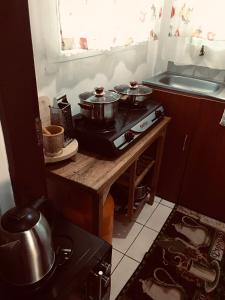 a kitchen with two pots on top of a stove at Stone Island in Kisumu