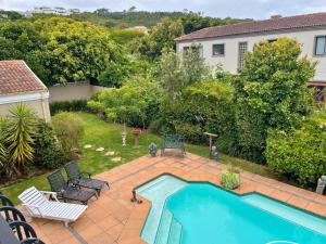 an aerial view of a backyard with a swimming pool at Calm Waters Guesthouse: Robberg Room in Plettenberg Bay