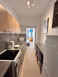 a kitchen with a stove and a counter top at Peraia Studio in Perea