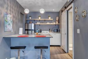 a kitchen with a blue island with two bar stools at Budget friendly studio apt in historic Springfield in Jacksonville