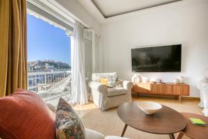 a living room with a large window with a view at SMG Boutique Apartments in Athens