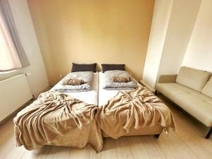 a bedroom with a bed and a couch in it at Double Room in the black Forest in Villingen-Schwenningen