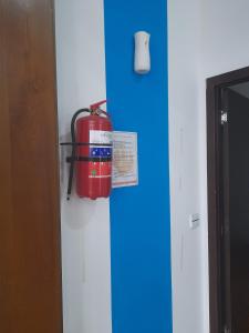 a fire hydrant on the wall of a room at White city hostel in Baku