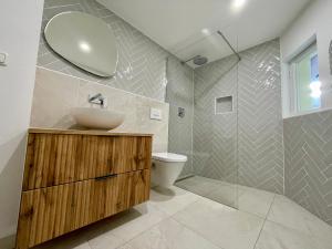 a bathroom with a sink and a toilet at Modernes Altstadt Apartment in Bad Belzig