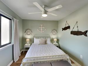 a bedroom with a bed and a ceiling fan at Lighthouse Point 7c in Tybee Island