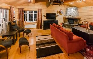 a living room with a couch and a fireplace at Cozy Home In Uvdal With Kitchen in Uvdal