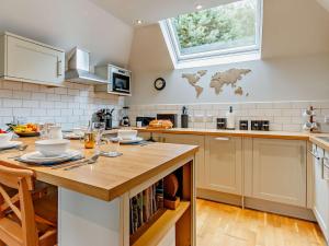 a kitchen with a wooden counter top and a table at 2 Bed in Tarbert 85374 in Tarbert