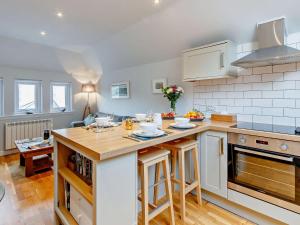 a kitchen with a counter top and a table at 2 Bed in Tarbert 85374 in Tarbert