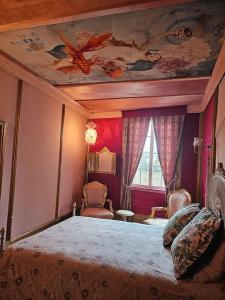 a bedroom with a large bed with a painting on the ceiling at PALCO EXOTICO LDA in Porto