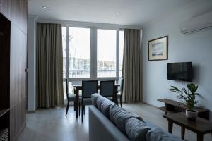 a living room with a couch and a table at Kordon Apartment in Fethiye