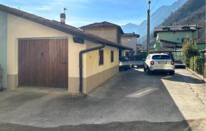 a car parked in a parking lot next to a house at Stunning Apartment In Bagolino, F Pcaffaro in Ponte Caffaro