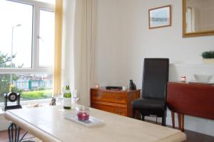 a room with a desk and a chair and a window at Beach Vista Apartment One in Barmouth in Barmouth