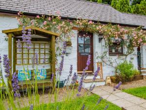 a cottage with flowers on the front of it at 1 Bed in Narberth 77692 in New Moat