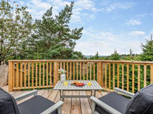 a wooden deck with a table and two chairs at 1 Bed in Totnes 93063 in Marldon