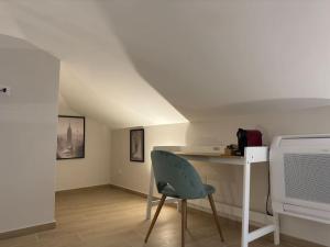 a white room with a chair and a table at Fronte lago , mansarda da favola in Trevignano Romano +1 photo