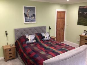 a bedroom with a bed and a couch at Taigh Sealladh Fèidh B&B in Fort Augustus